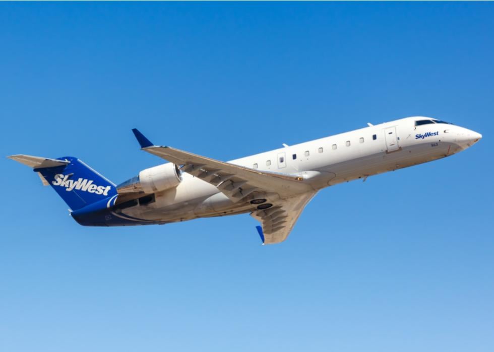 A SkyWest Bombardier CRJ-200 airplane flying in the sky