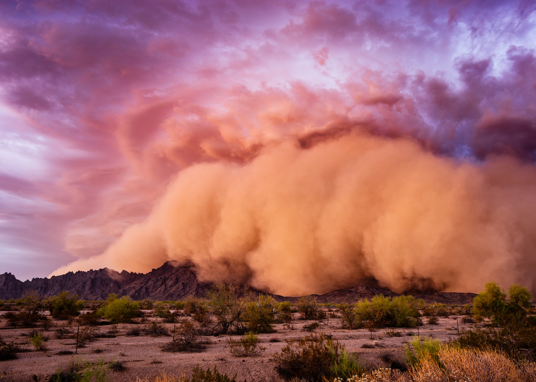 An ominous dust storm moves over land.