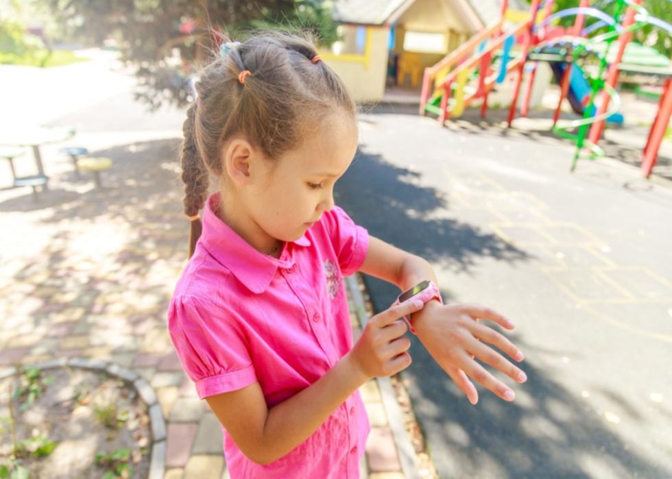 A young girl with a smart watch.